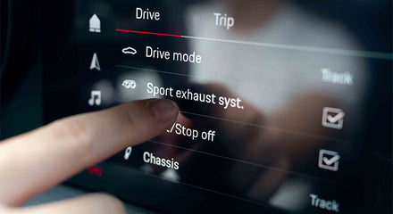 A man pointing his finger on 992 GT3's control panel - desktop version