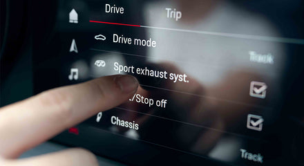 A man pointing his finger on 992 GT3's control panel - mobile version